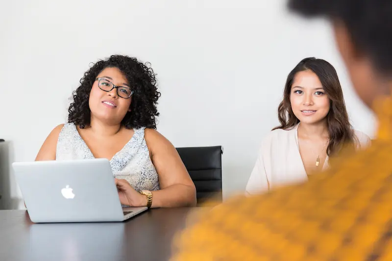 Two businesswomen interviewing a digital agency